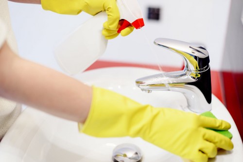 Local cleaner treating a stained sofa in Haringey apartment