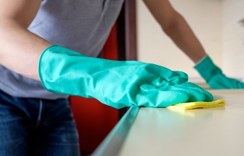 Trained carpet cleaner using professional equipment with protective gear