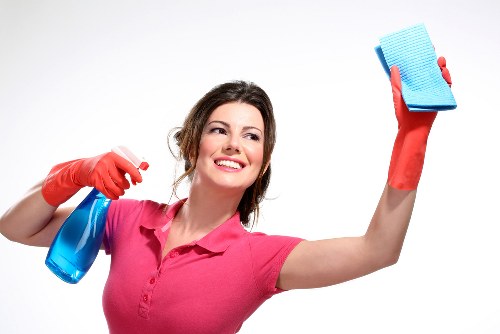Cleaner maintaining desks and shared office surfaces